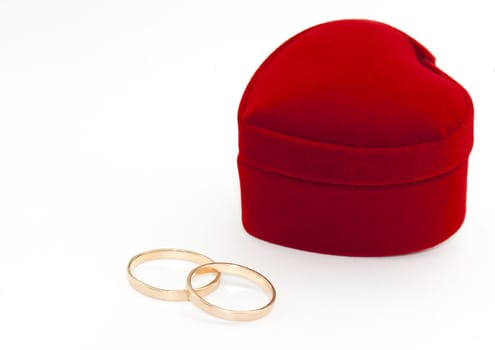 Two rings and heart shaped red box