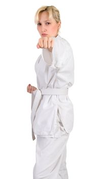 Blonde in a kimono in karate pose isolated on white background.