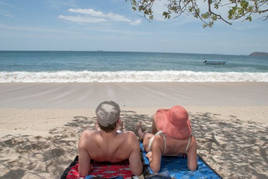 A couple of German tourists relax and enjoy their stay at a beach in Costa Rica