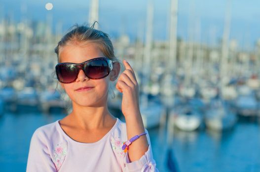 Closeup Portrait of a cute girl in the background of yachts