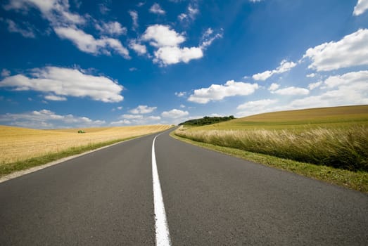  An empty road with a white line down the middle.