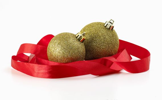 gold christmas balls wrapped in red ribbon
