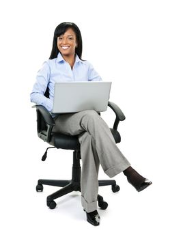 Young smiling black business woman sitting in leather office chair with laptop computer