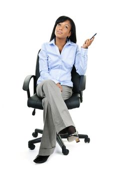 Young black businesswoman sitting and thinking in leather office chair