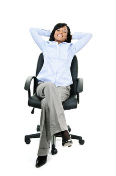Young smiling black businesswoman relaxing sitting in leather office chair