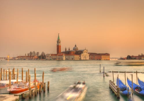 Sunset in Venice on the San Giorgio Island.In the distance can be seen The Church of San Giorgio Maggiore, designed by Andreea Palladio and a Benedictine monastery.