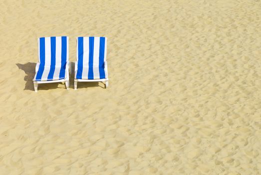 two empty chairs on a beach