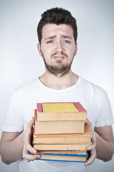 Isolated image of a sad student holding many books