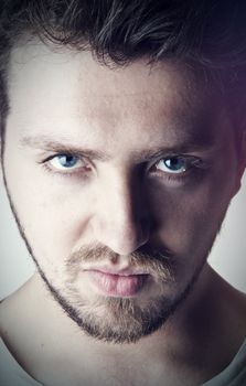 Macro portrait of a young, handsome man with blue eyes