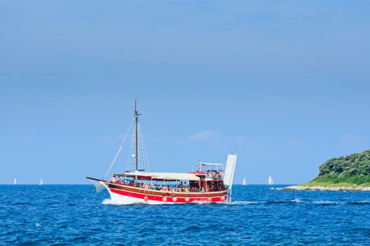 Red Tourists floating on a boat on the sea of Adriatic