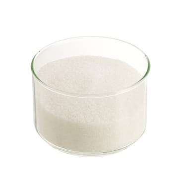 White sugar in round glass bowl isolated on white background