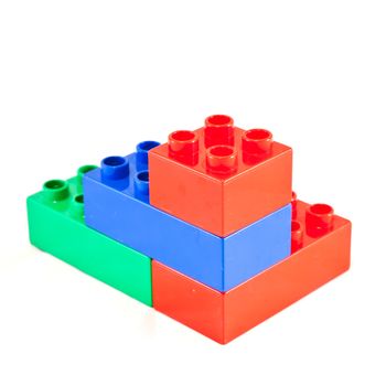 Plastic building blocks on white background. Bright colors.