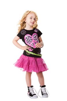 Happy smiling child girl in fashion rock and roll outfit shirt and skirt with attitude expression, isolated.