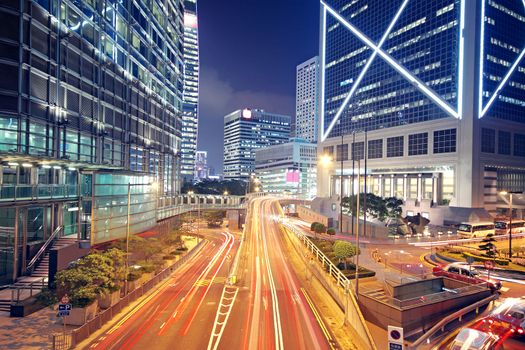 modern urban city at night with freeway traffic