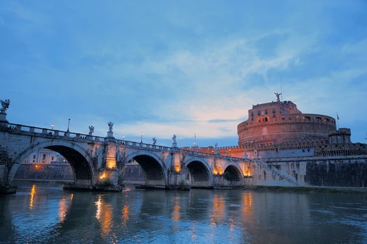 Bridge crossing the river Tiber and Castle in twilight