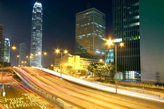 Colorful city night with lights of cars motion blurred in hong kong