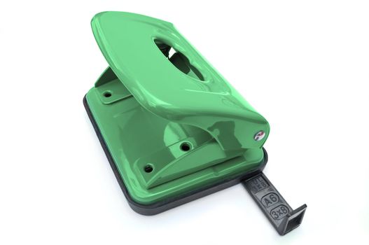 Close up of a single green hole puncher arranged over white