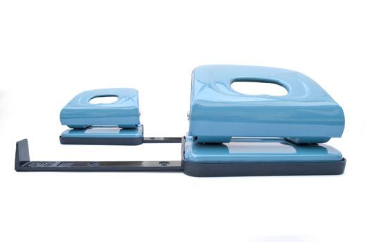 Close up of two blue hole punchers arranged over white