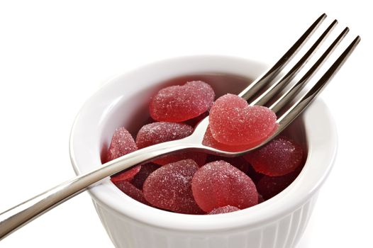 Red heart shaped jelly sweets on with a fork