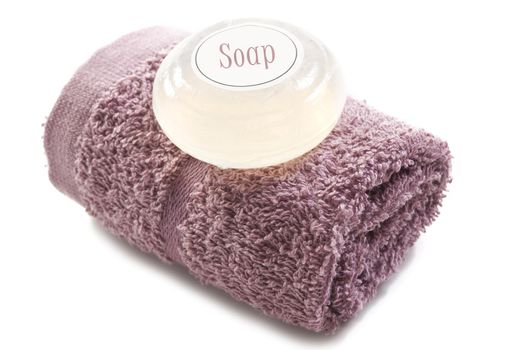 Pink towel with soap on a white background