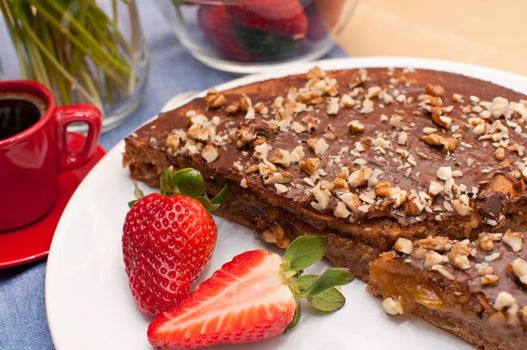 Walnut Cake With Strawberries and Cup of Coffee on Table