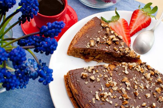 Walnut Cake With Strawberries and Cup of Coffee on Table