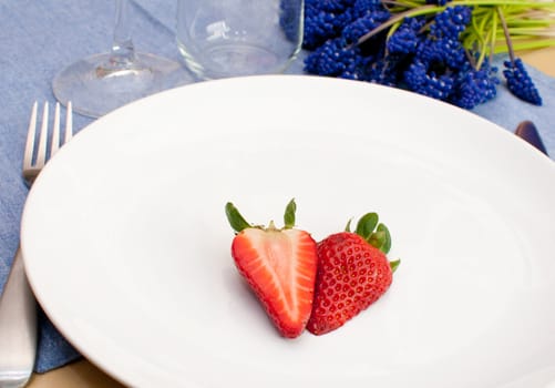 Halved Strawberry on Empty White Plate on Table