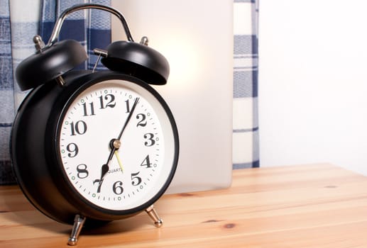Alarm Clock and Reading Lamp on Bedside Table