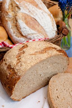 Bread and Rolls in Basket on the Table