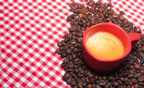 Cup of Coffee and Coffee Beans on Red Gingham cloth