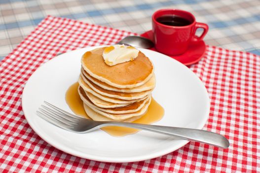 Pancakes With Butter and Warm Maple Syrup On The Table