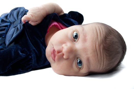 A cute newborn baby infant on a white backdrop.