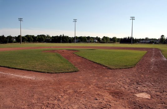 A view of a baseball diamond at dusk.