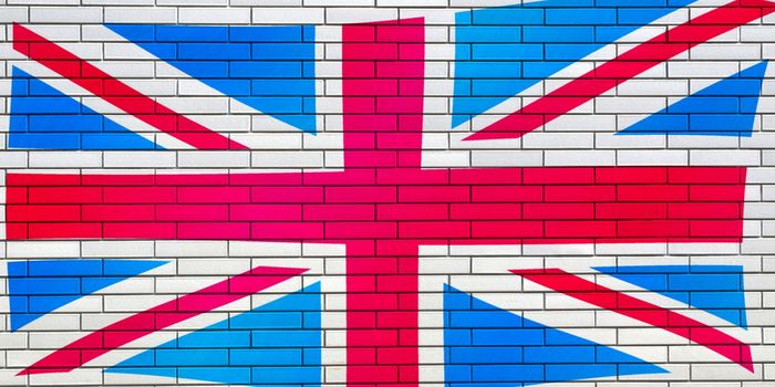 Grunge illustration of the Union Jack flag of the United Kingdom UK with white brick background