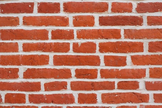 A pattern of red rectangular natural brick textured blocks.