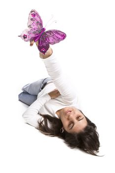young casual woman playing with pink butterfly