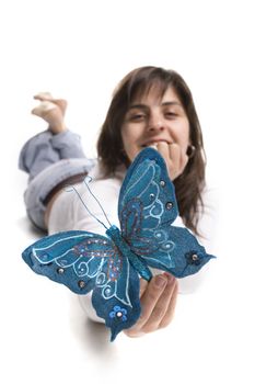 Young woman holding blue butterfly