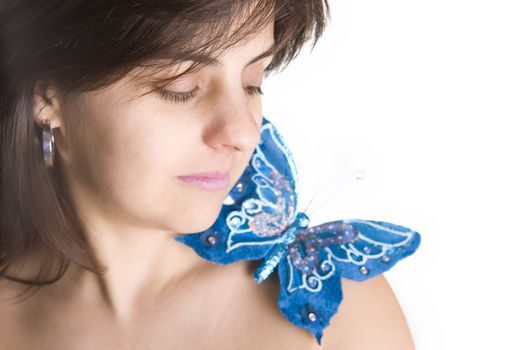 beautiful young woman with blue butterfly in her naked shoulder - focus on the eye