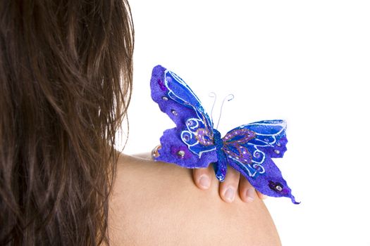 blue butterfly resting on woman naked shoulder