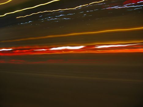 Abstract light trails captured from cars, signs, and other landmarks.