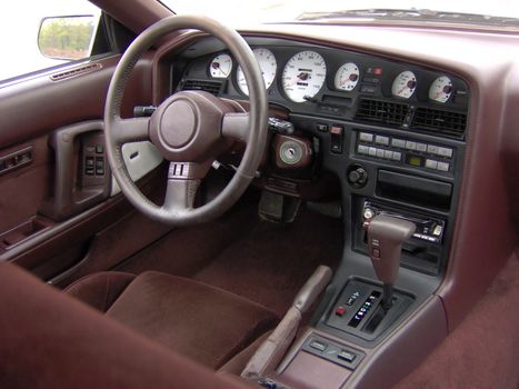 Sports car cockpit / interior.  Custom electro luminescent gauges in white carbon fiber.
