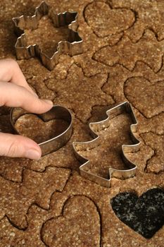 Mixed cookie cutters on wooden table.

