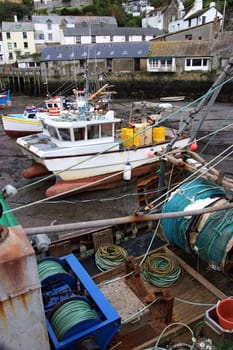 Fishing boats in dock at low tide