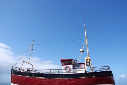 A bright red fishing boat at sea