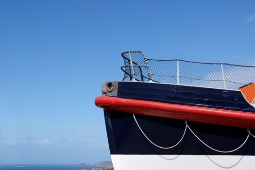 The bow of a sea rescue ship against red sky