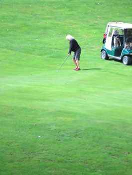 Senior golfer playing in a tournament.