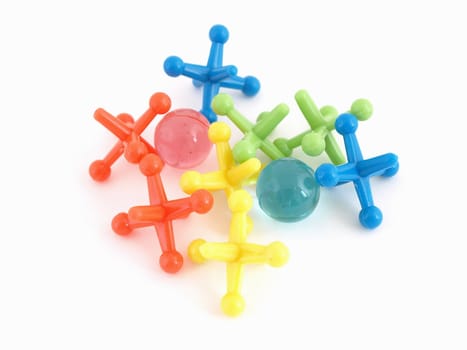 Colorful plastic toy jacks and balls isolated on a white background