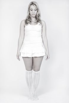 Studio portrait of a long blond girl looking very neutral