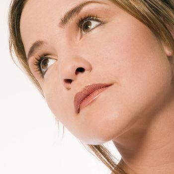 Young caucasian woman in the studio looking up