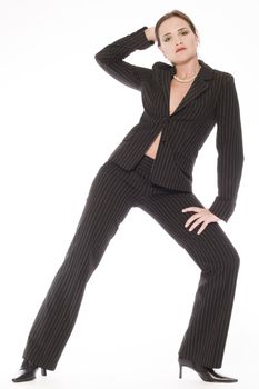 Young caucasian woman in the studio posing in a suit